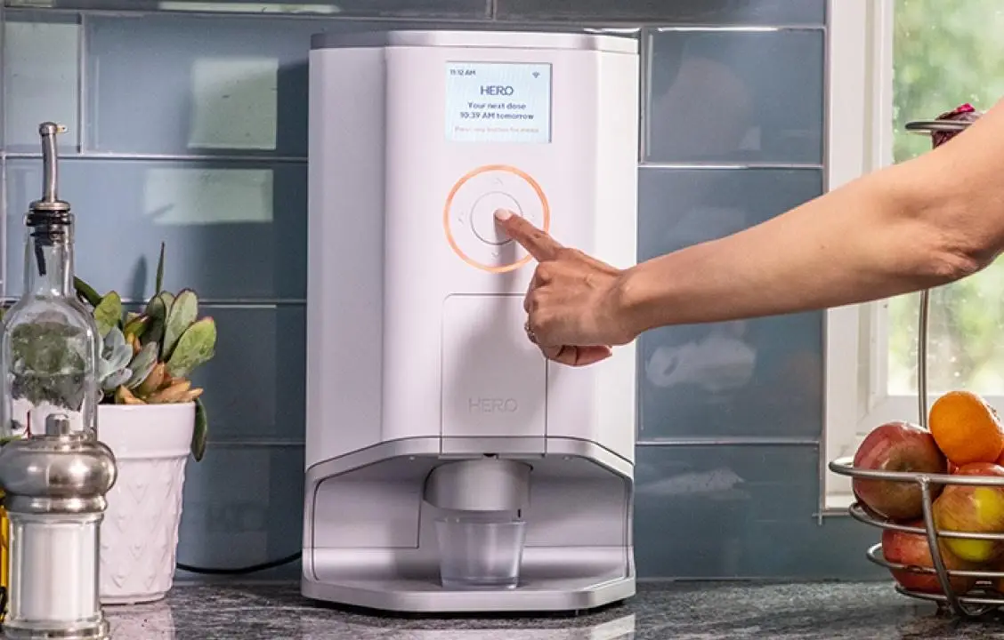 device on table with hand